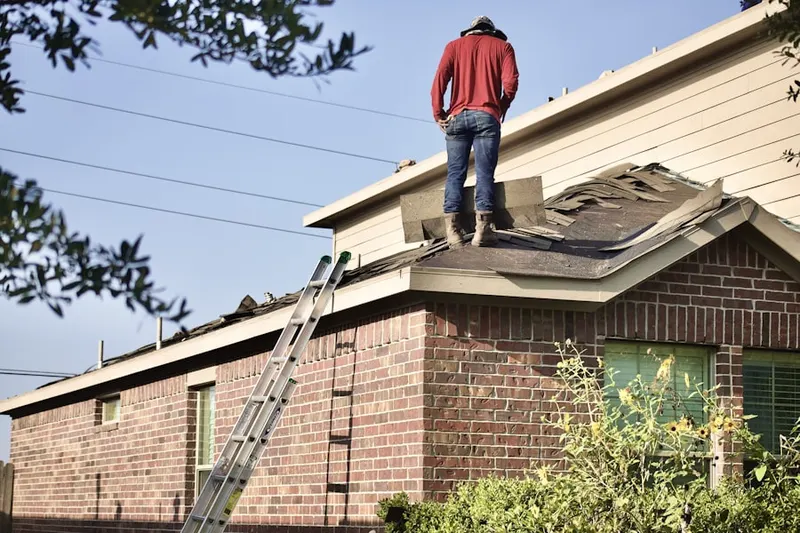 Professional roofer working on a residential roof in Belingham Square